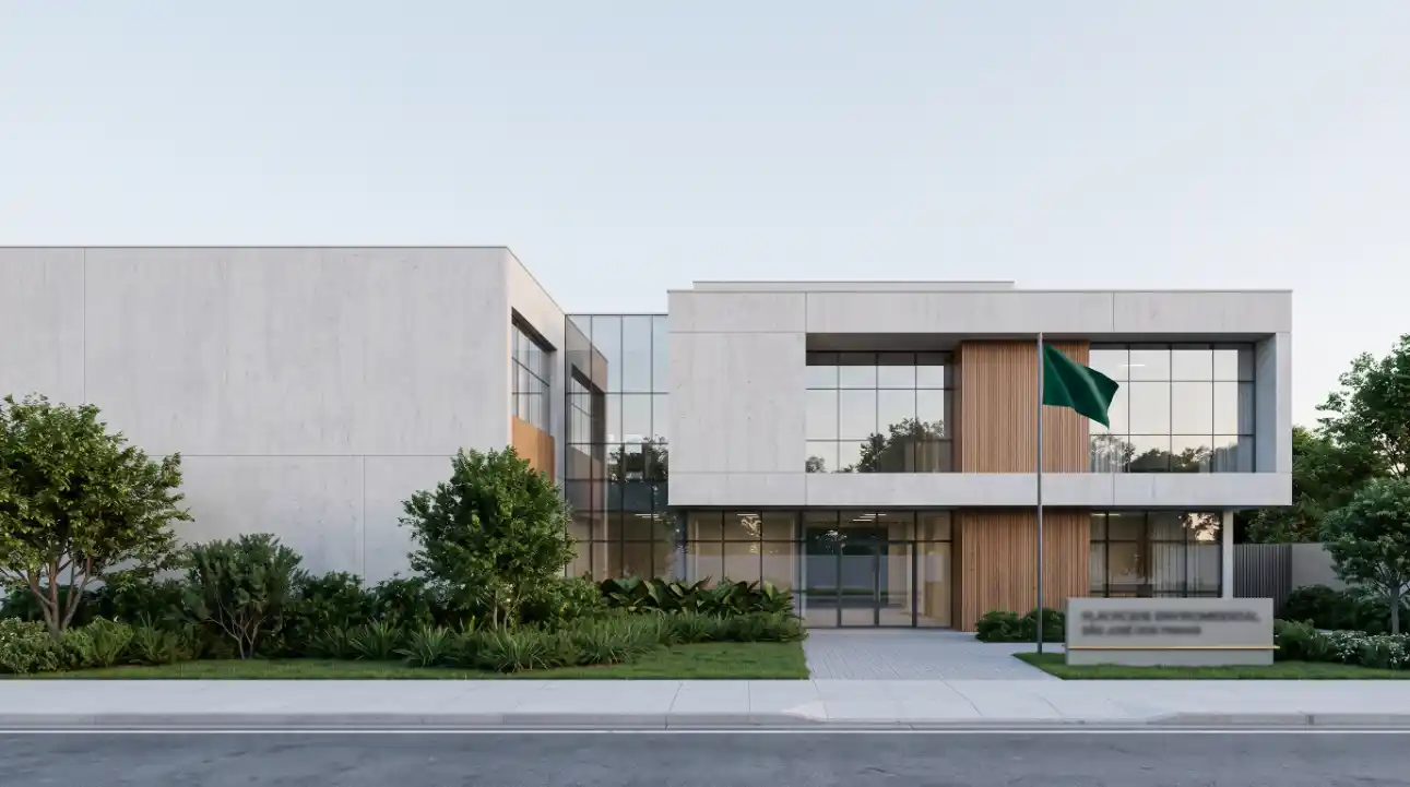 Fachada moderna de prédio corporativo com elementos de concreto, grandes janelas de vidro e entrada central, cercada por jardim com vegetação e calçada de acesso